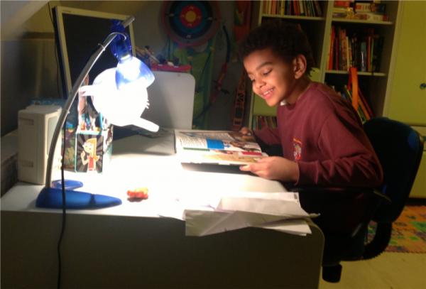 A boy reading at a desk